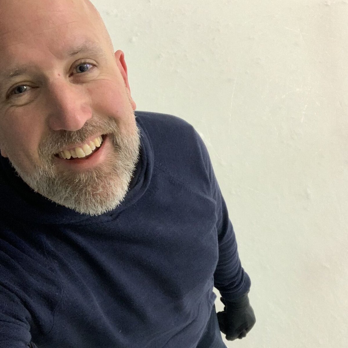 Smiling selfie of Neil Martin in a navy jumper on the day he went back on skates for the first time in over 15 years