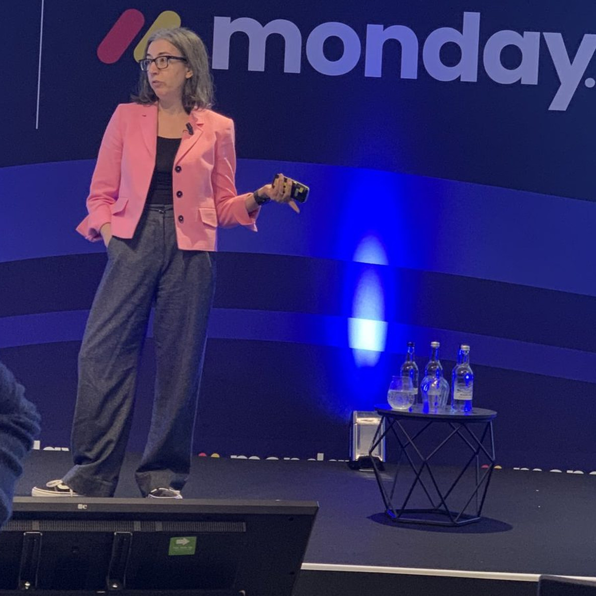 Beth Ayers of Metomic speaking on stage at aiblLIVE London in a pink jacket